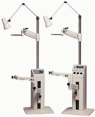 Medical equipment with adjustable arms and lamps.