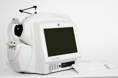 A Zeiss OCT Cirrus 4000 with a mouse and keyboard sitting on top of it.