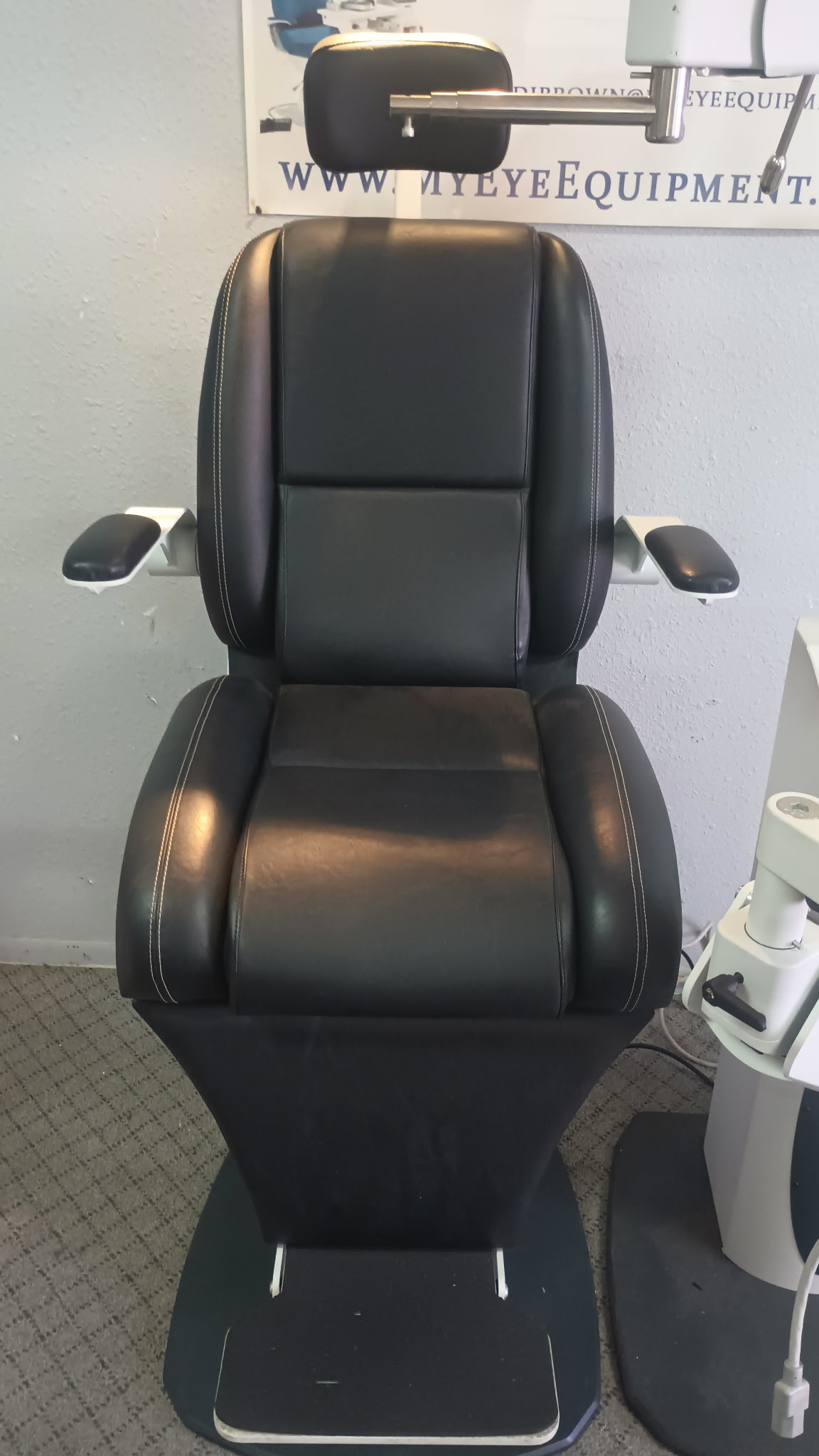 Black leather ophthalmology examination chair.