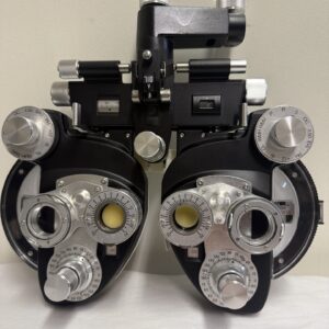 Optometry phoropter with various adjustment dials.